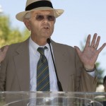 Tom Bates speaking at the podium.